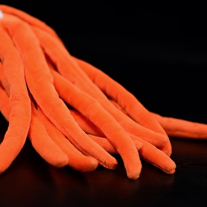 Close-up of Orthoceras plush toy’s tentacles, showing vibrant orange color and smooth fabric