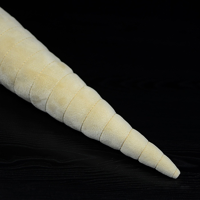 Close-up of Orthoceras plush toy’s pointed shell tip, showcasing its detailed stitching and design