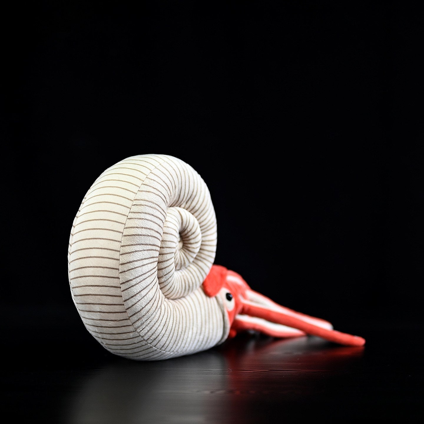 Rear angle of Perisphinctes ammonite plush displaying its spiral shell and lifelike design