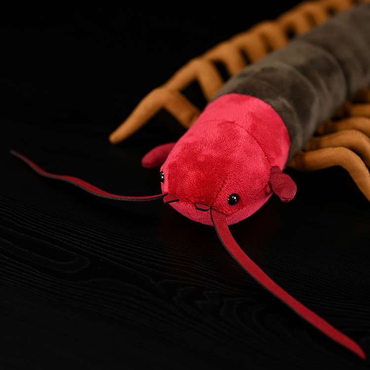 Close-up of the red head of Chinese centipede plush toy, with detailed antennae and realistic stitching design