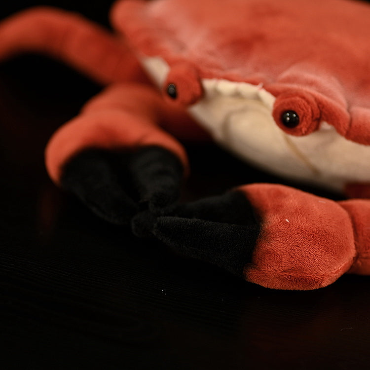 Close-up of the claws of the Edible Crab Plush by SoftDaysLab, featuring lifelike black details for added realism
