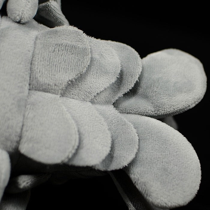 Close-up of giant isopod plush underside, highlighting soft texture and realistic design