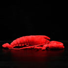 Side view of American lobster plush toy highlighting its realistic segmented body and soft finish