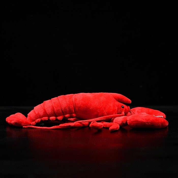 Side view of American lobster plush toy highlighting its realistic segmented body and soft finish