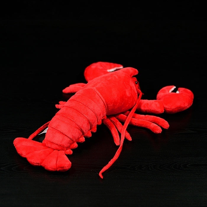 Back view of American lobster plush toy displaying detailed tail and vibrant red coloration