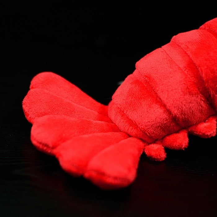 Tail view of the American lobster plush toy, featuring detailed segments and a soft, vibrant finish