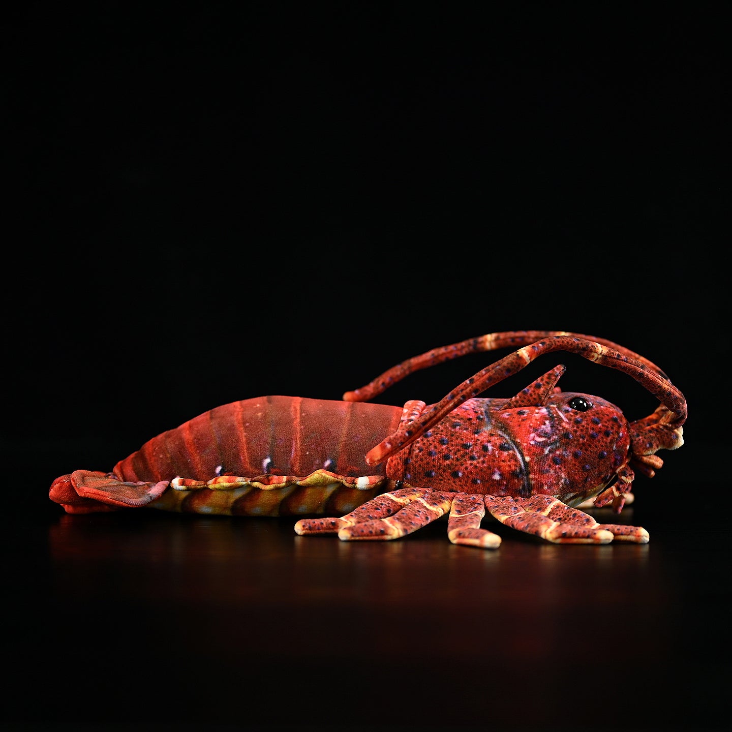 Side view of a Japanese spiny lobster plush toy highlighting vibrant shell patterns and soft design