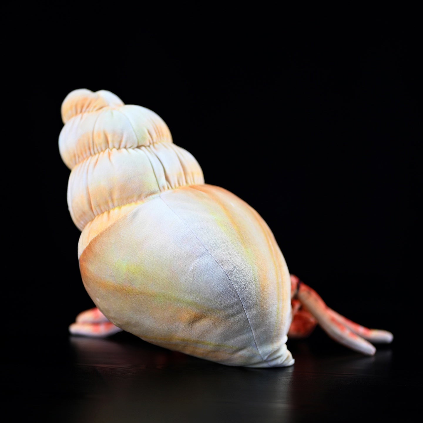 Back view of hermit crab plush toy highlighting the soft, realistic shell design