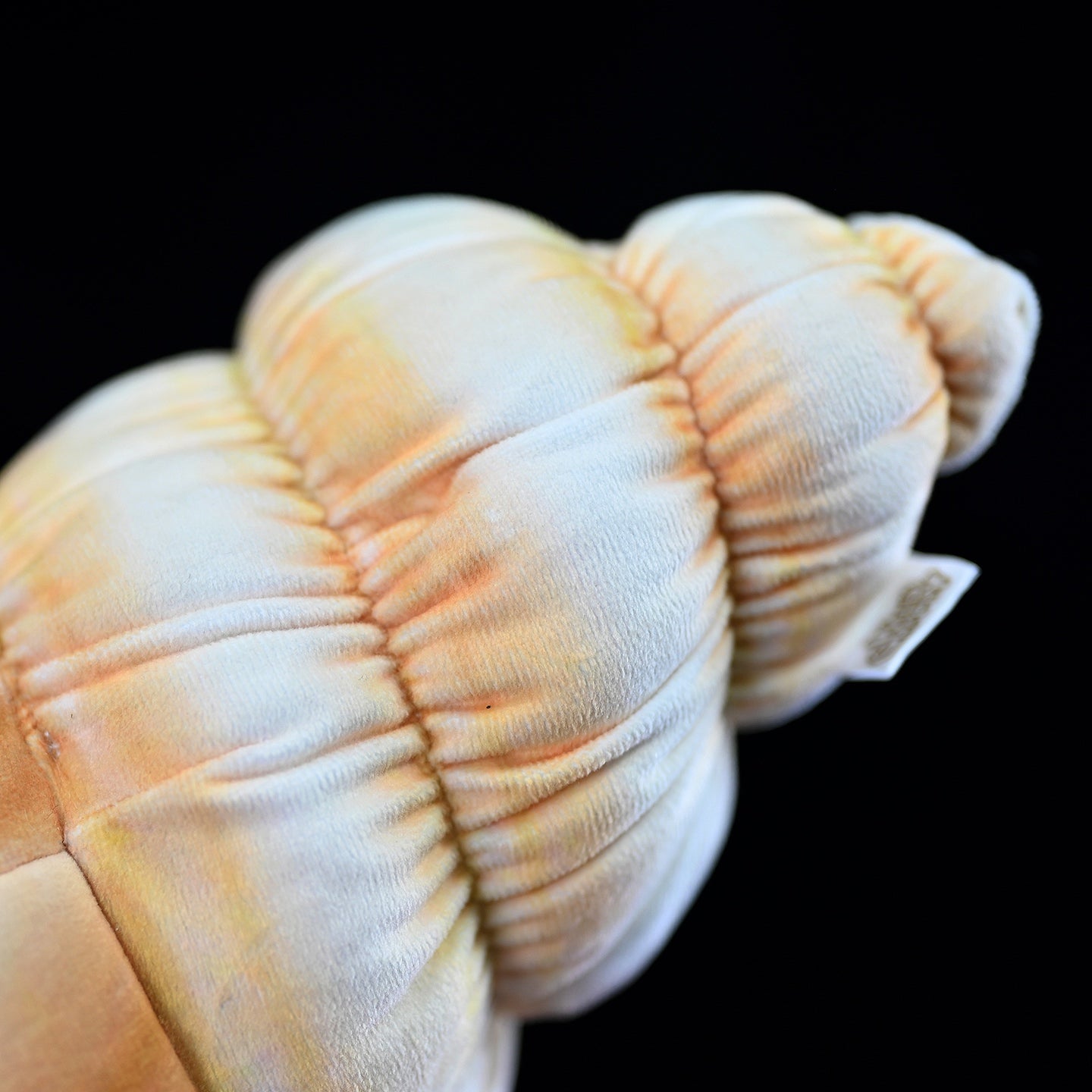 Close-up of hermit crab plush shell, highlighting soft, detailed texture and vibrant hues