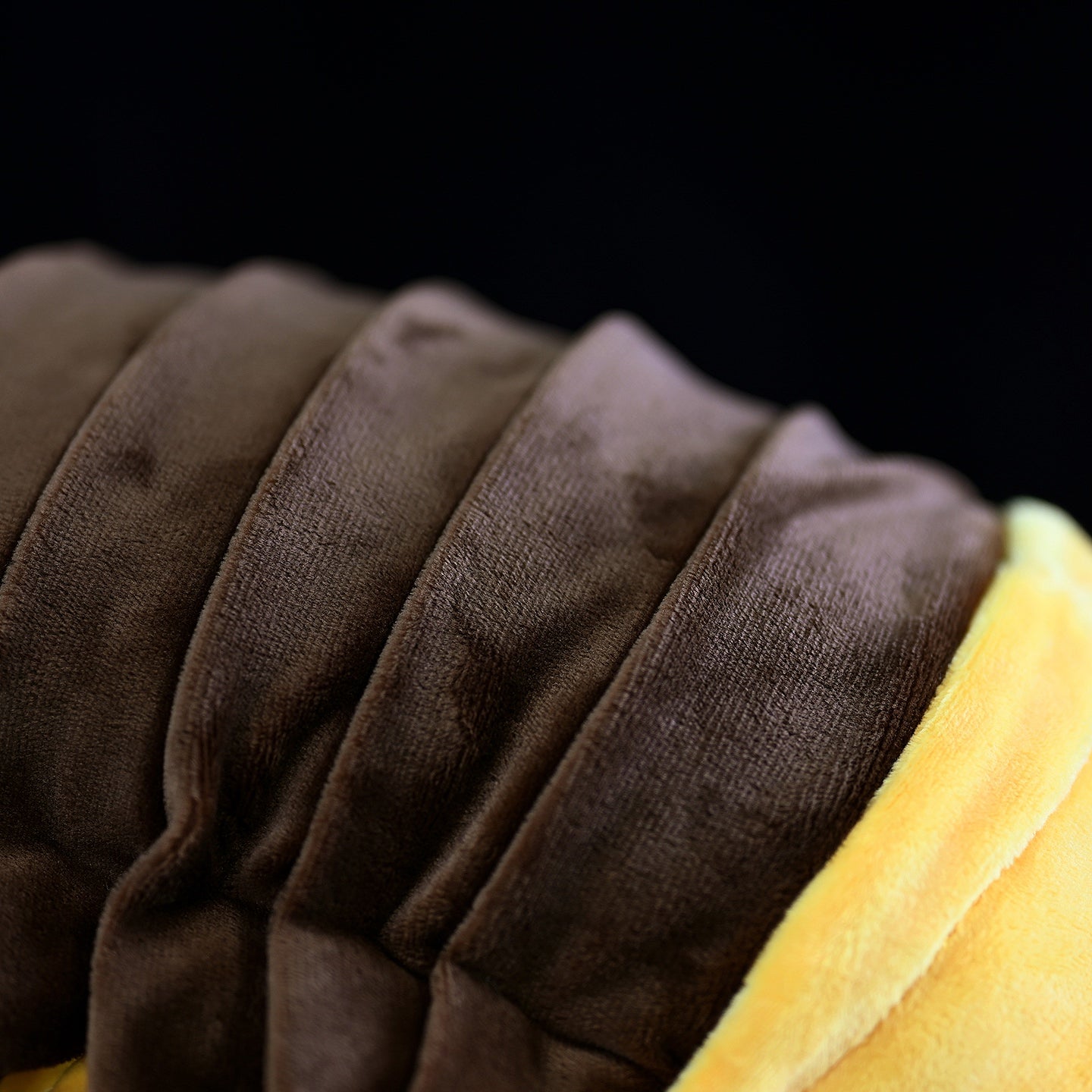 Detailed view of the plush toy's segmented back, showcasing its high-quality fabric and lifelike texture