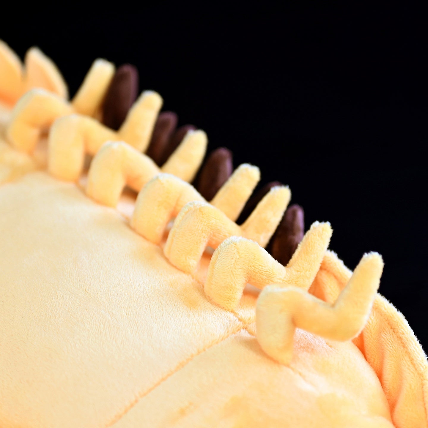 Close-up of the isopod plush's underside, emphasizing its intricate leg details and soft plush material