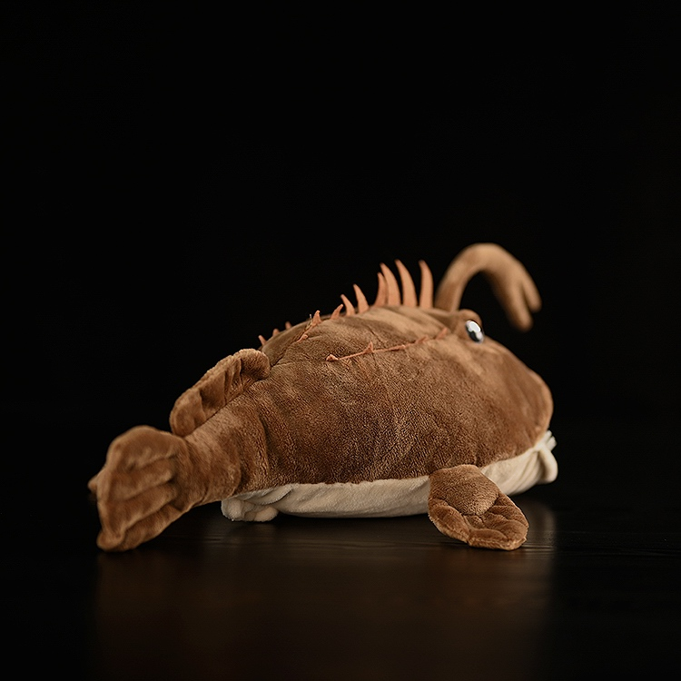 Rear view of American Monkfish plush toy, highlighting the fins and textured body for a realistic look