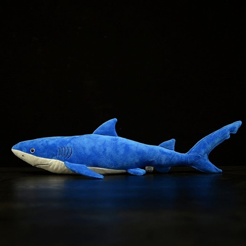 Side profile of the blue shark plush toy by SoftDaysLab, highlighting its realistic body and soft texture