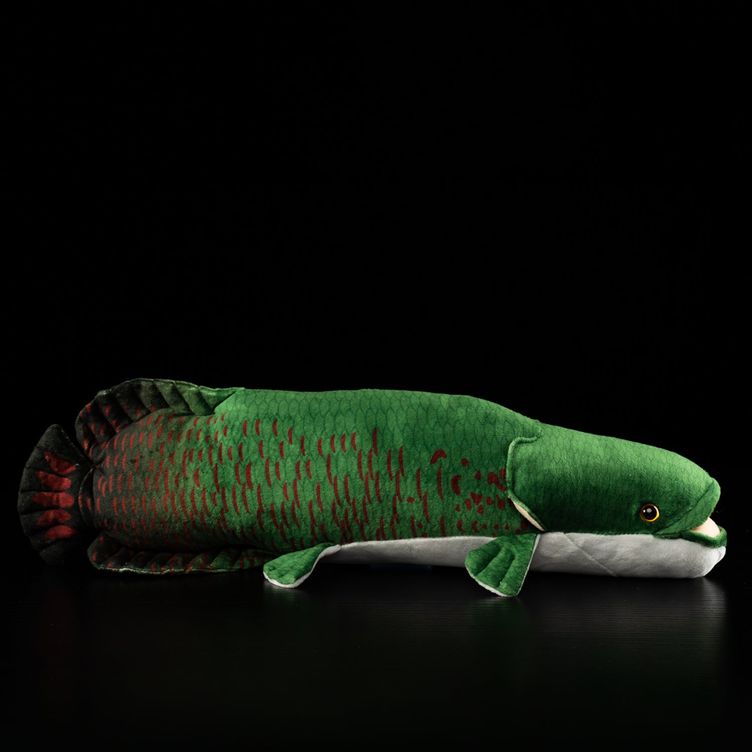 Full side profile of the Arapaima gigas plush crafted by SoftDaysLab, capturing its lifelike details and vibrant freshwater fish patterns