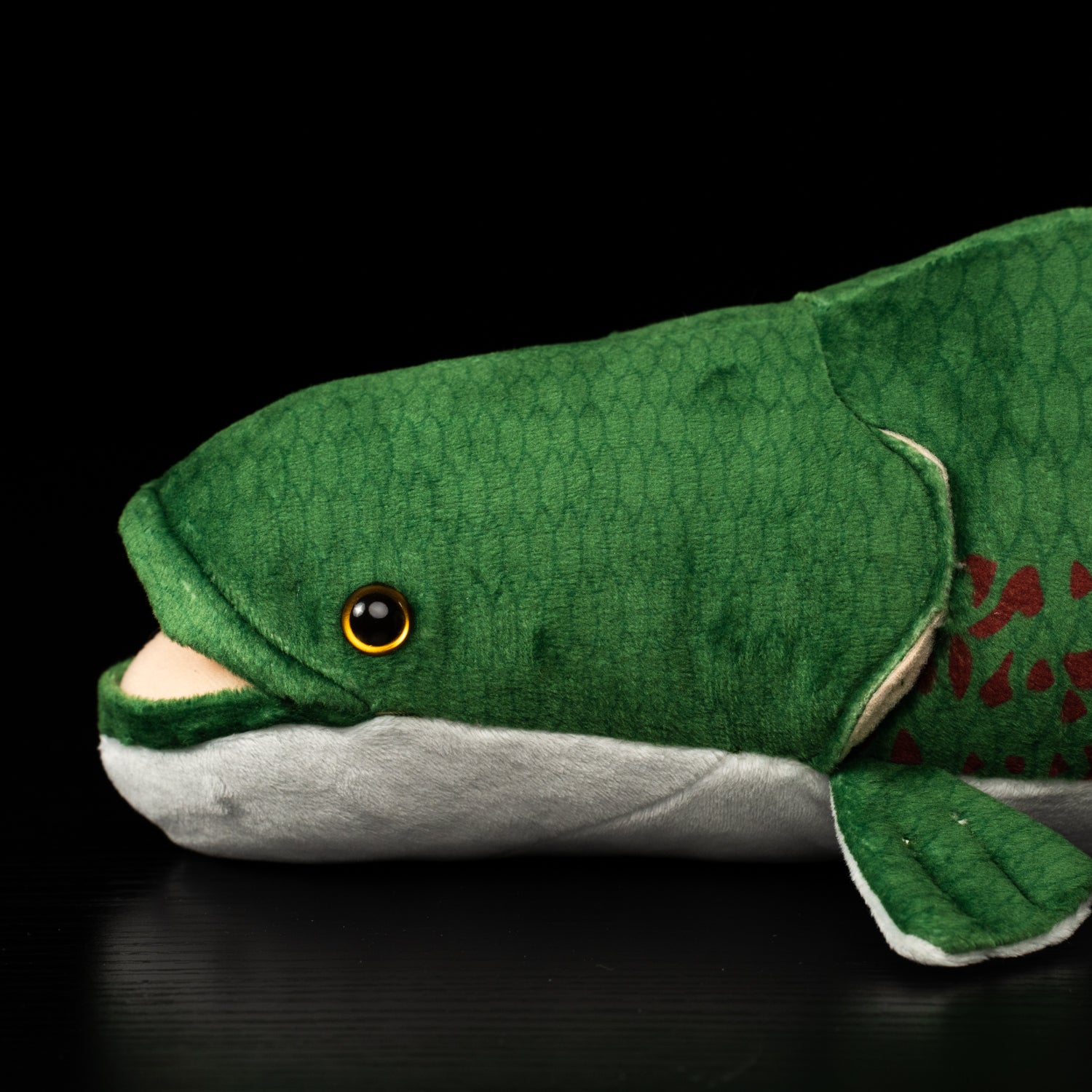 Close-up of the Arapaima’s lifelike head and soft texture, highlighting its realistic fish plush features