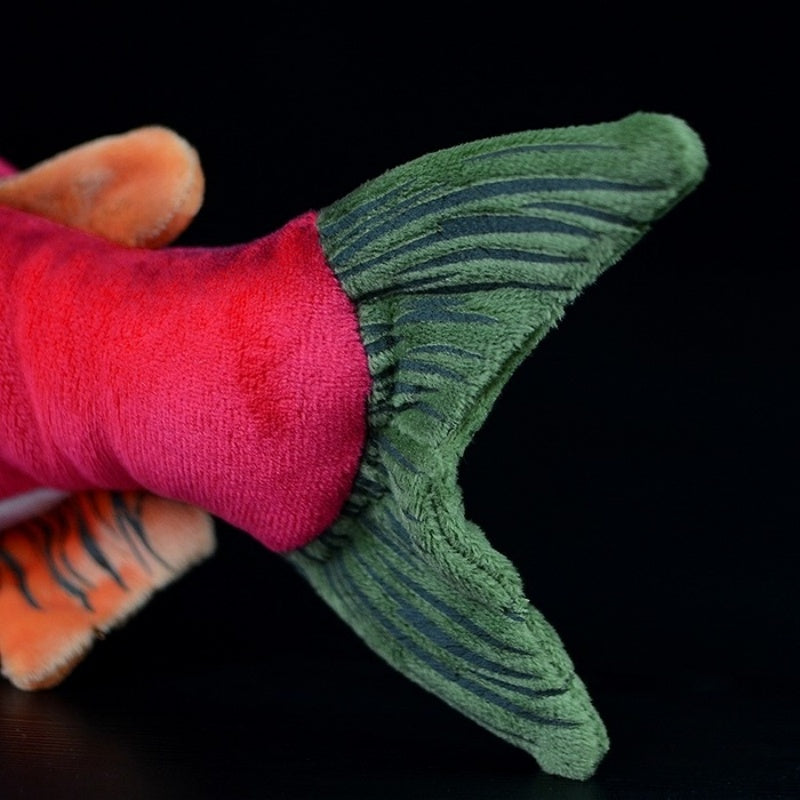 Tail close-up of the sockeye salmon plush toy, featuring green and black detailed patterns