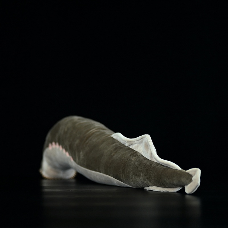 Angled rear view of sea lamprey plush toy showing smooth body and soft fabric texture
