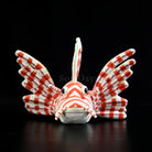 Head-on view of red lionfish plush showcasing lifelike design and striking striped pattern