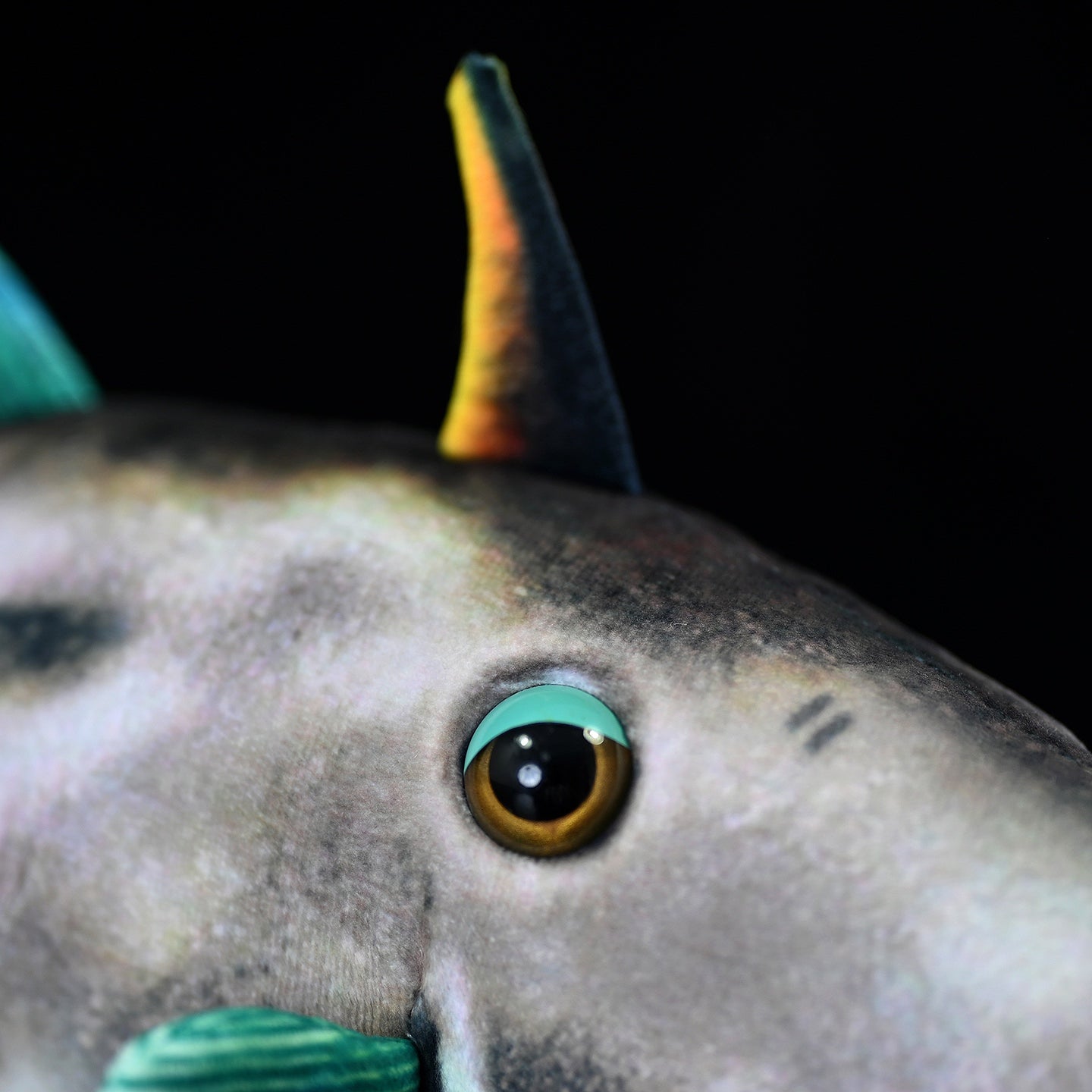 Close-up of Greenfin Horse-Faced Filefish plush’s eye and fin, showcasing lifelike marine animal details