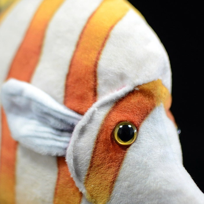 Detailed view of the lifelike eye and colorful pattern of a Copperband Butterflyfish stuffed toy