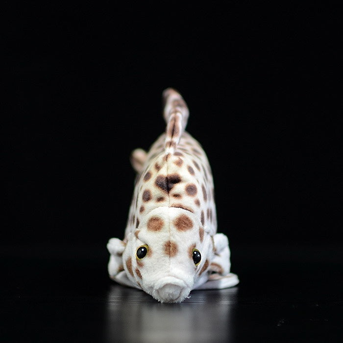 Front view of a lifelike spotted scat stuffed animal with realistic spots and soft texture