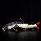 Side profile of Redtail Catfish Plush highlighting its bold red tail and realistic body patterns