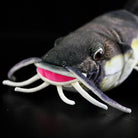 Close-up of Redtail Catfish Plush head, featuring detailed whiskers and vivid facial features
