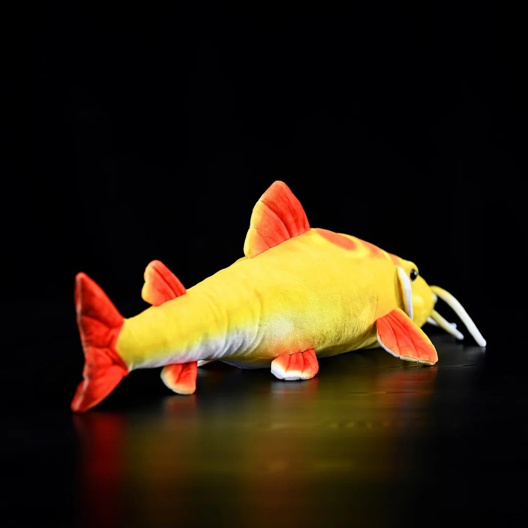 Back angle of Golden Redtail Catfish Plush by SoftDaysLab® highlighting its bright red tail and fins