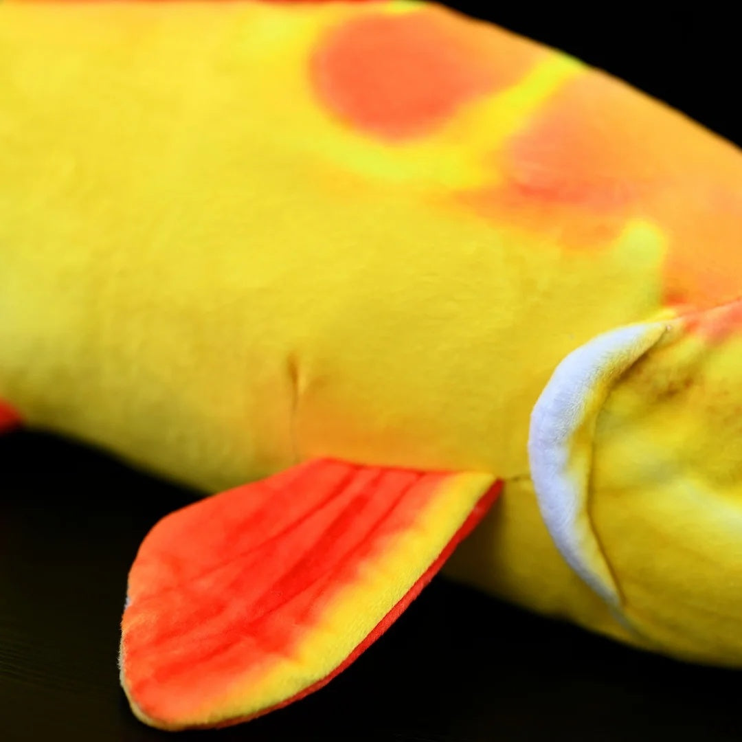 Body close-up of Golden Redtail Catfish Plush by SoftDaysLab®, highlighting vibrant yellow hues and realistic fins
