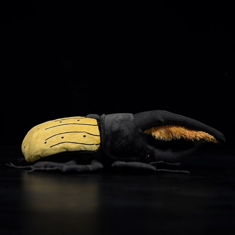 Profile view of a Hercules beetle plush with detailed yellow body and black accents by SoftDaysLab