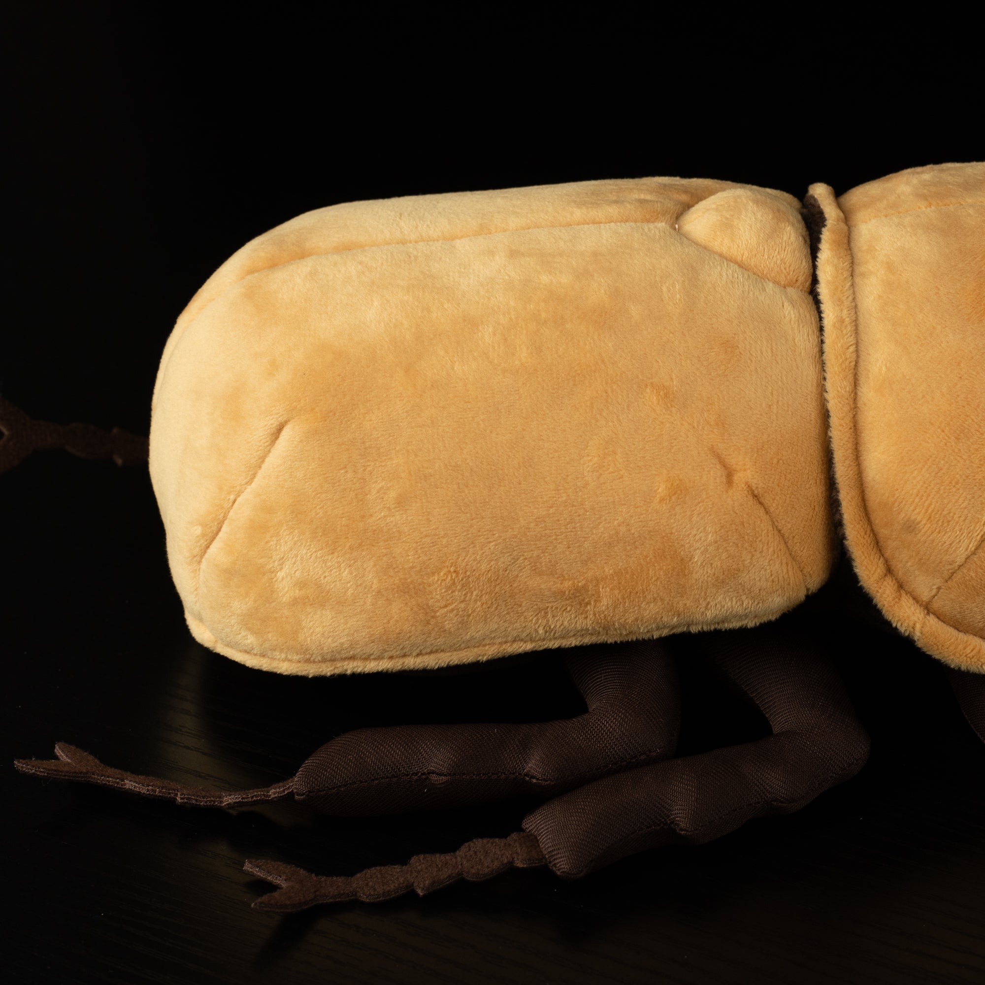 Detailing the legs of the SoftDaysLab® elephant beetle plush, perfect for rainforest-inspired gift ideas