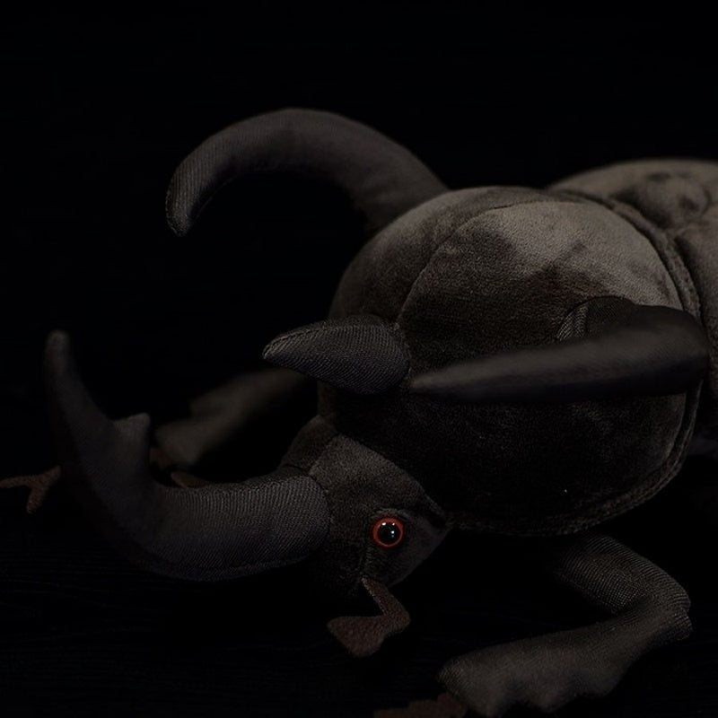 Close-up of the Atlas beetle plush toy's horns, emphasizing the lifelike shape and fine details