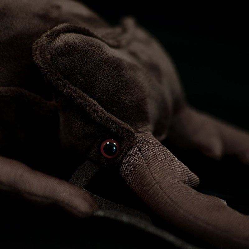 Zoomed-in view of the stag beetle plush toy’s head, featuring realistic red eyes and fine stitching by SoftDaysLab