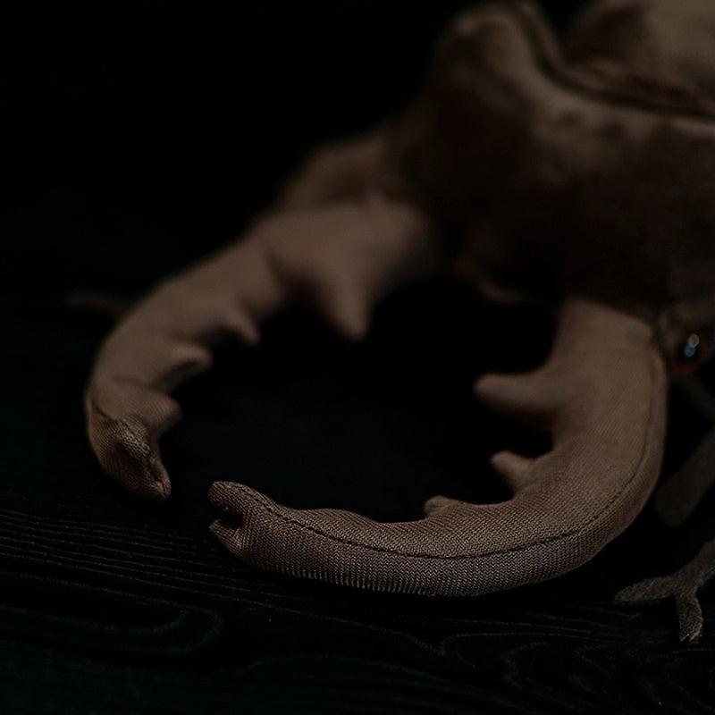 Close-up of the stag beetle plush toy's horns, emphasizing its lifelike and intricate design