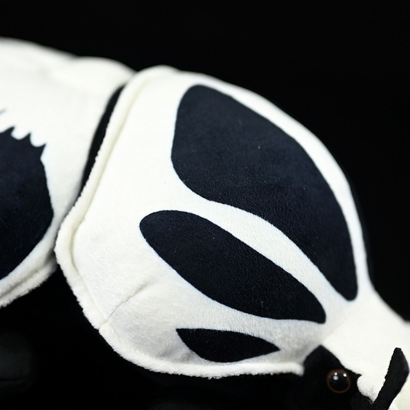 Detailed view of the Goliath beetle plush shell with black and white patterns