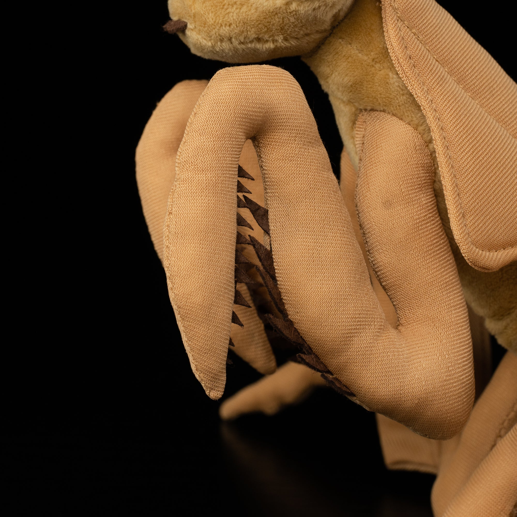 Detailed view of Dead Leaf Mantis plush legs by SoftDaysLab®, featuring lifelike mantis anatomy