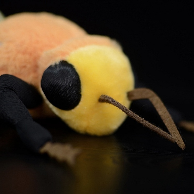 Close-up of bee plush toy's head, showcasing realistic antennae and soft texture