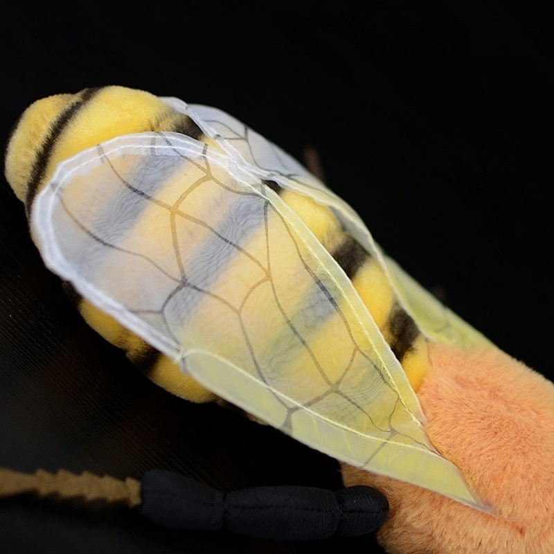 Zoomed-in view of bee plush toy's delicate wings with intricate pattern
