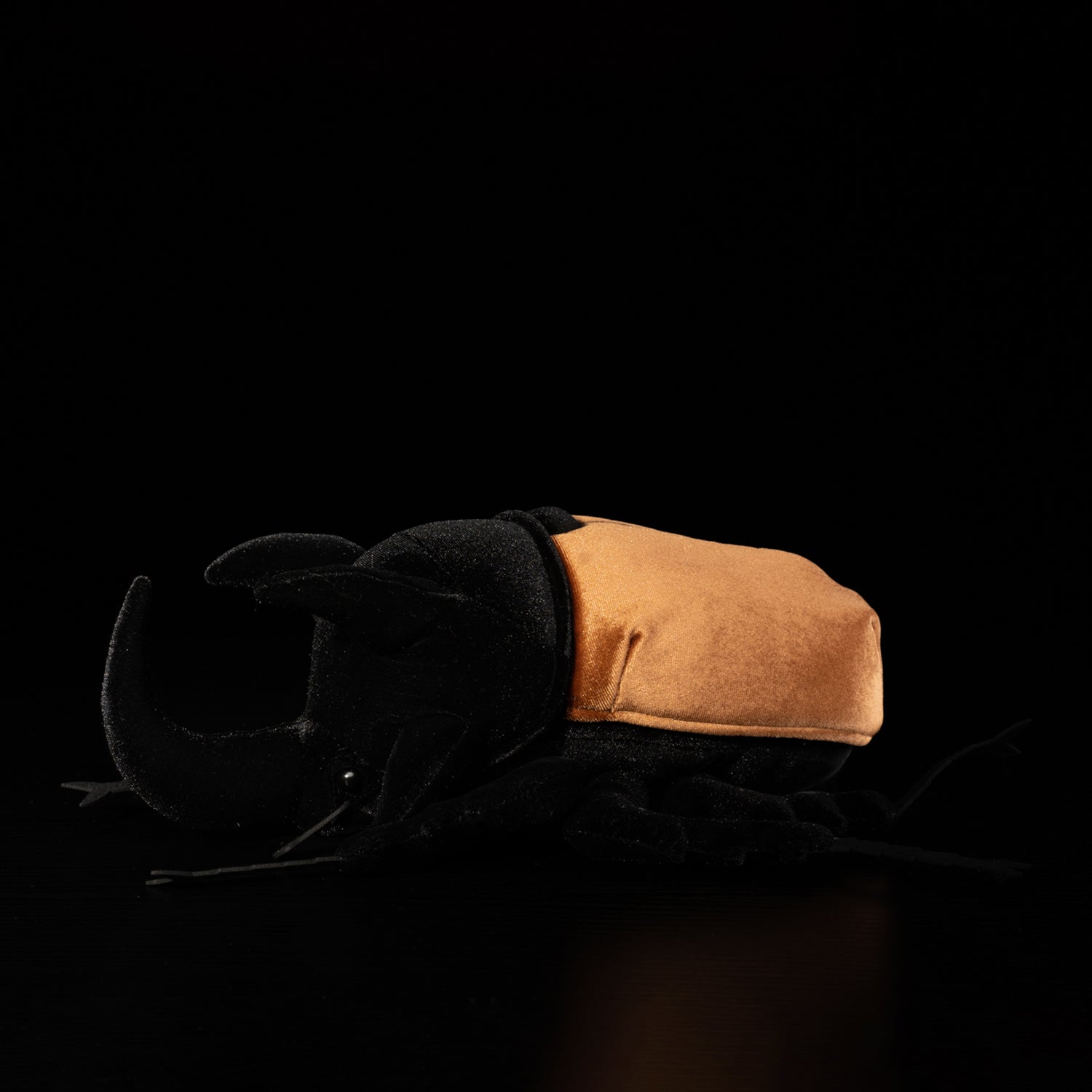 Profile of a realistic five-horned rhinoceros beetle plush with accurate horn structure and soft texture