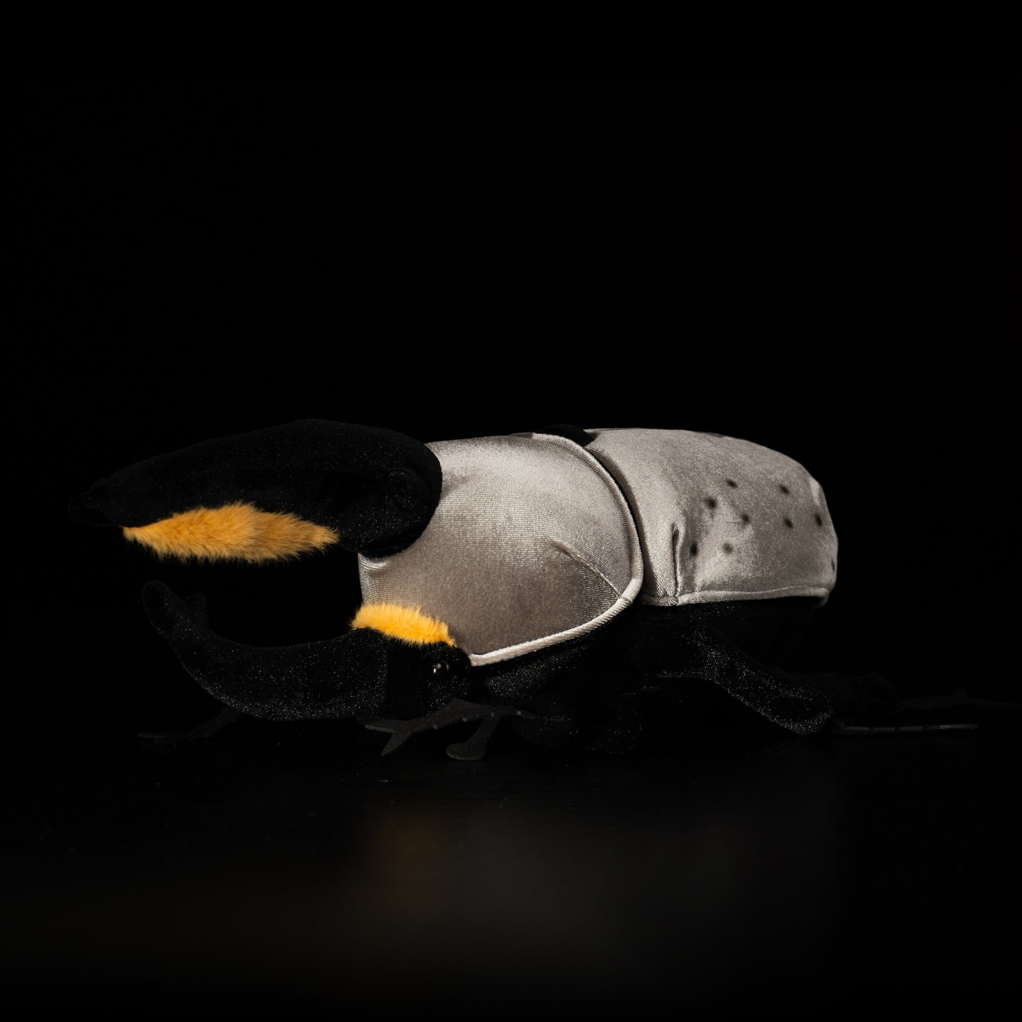 Side view of Western Hercules beetle plush with realistic horns and gray body by SoftDaysLab