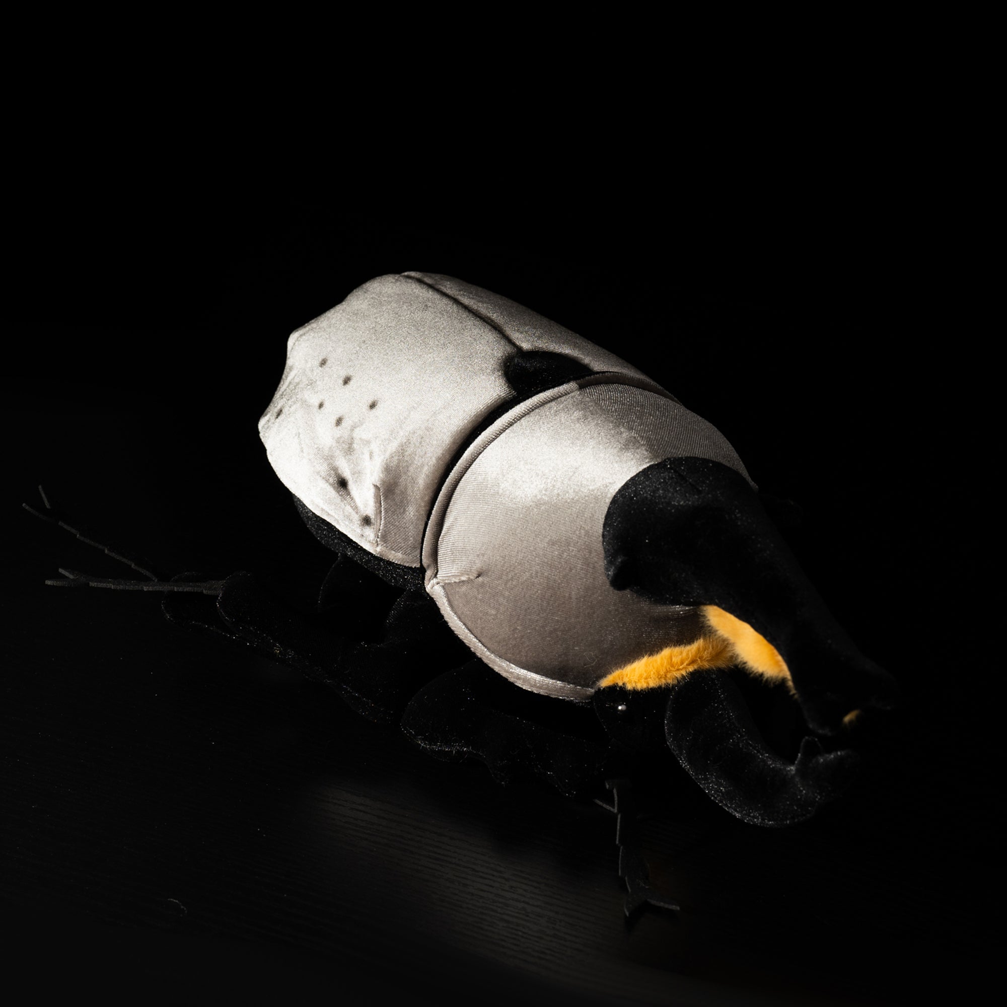 Side angle of plush Western Hercules beetle showing detailed black horns and lifelike features