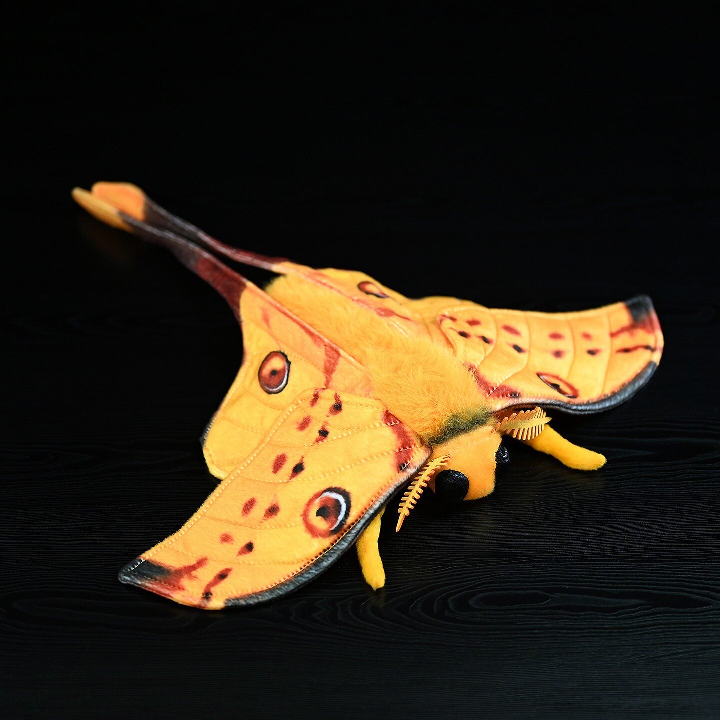 Realistic Comet Moth stuffed plush toy showing vibrant yellow wings with intricate details