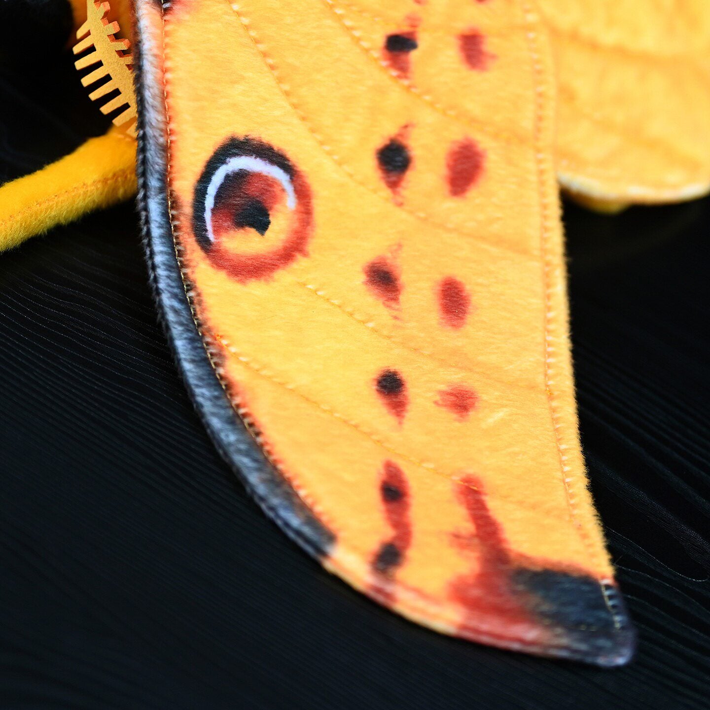 Detailed close-up of Comet Moth plush wing patterns, perfect insect-inspired decor or gift