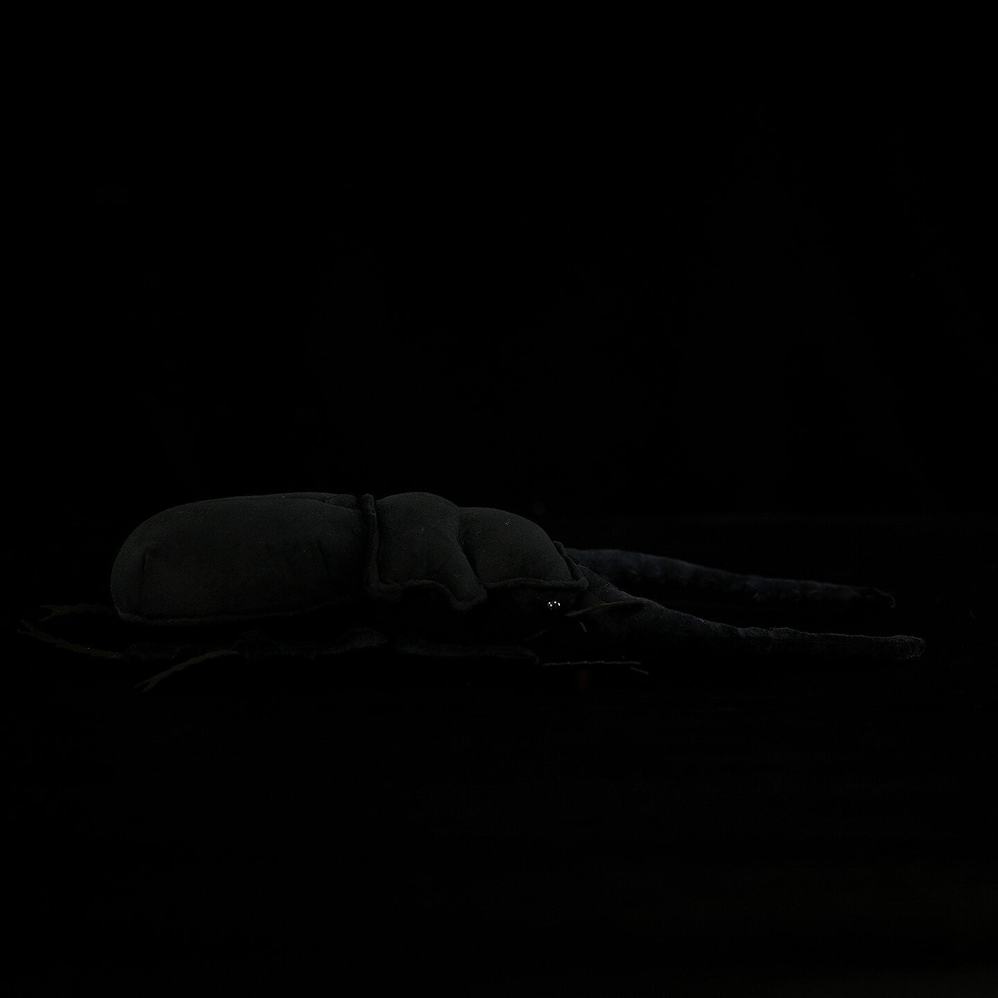 Side view of a detailed Giraffe Stag Beetle plush, capturing the realistic shape of this giant beetle