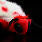 Zoom-in on the head detail of the Rosy Ermine Moth Plush by SoftDaysLab®, celebrating Trosia nigropunctigera's vibrant design