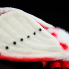 Close-up of the intricate spotted wings on the Rosy Ermine Moth Plush by SoftDaysLab®, inspired by tropical moths