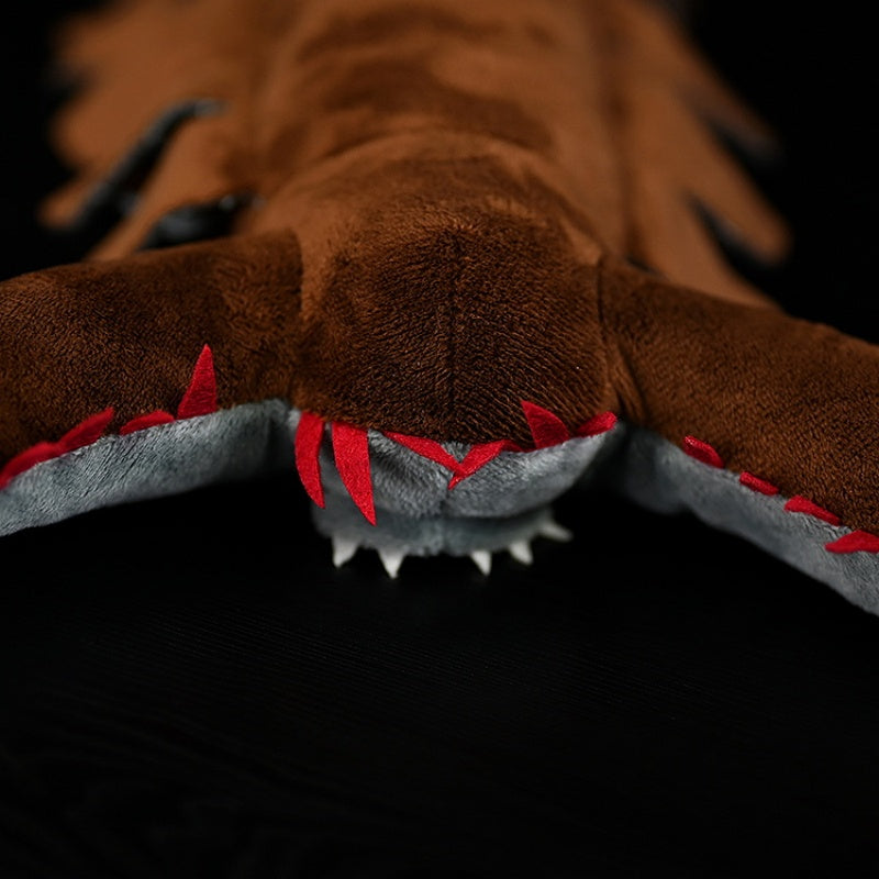 Close-up of the Omnidens plush toy's head, featuring detailed claw-like appendages and prehistoric accuracy