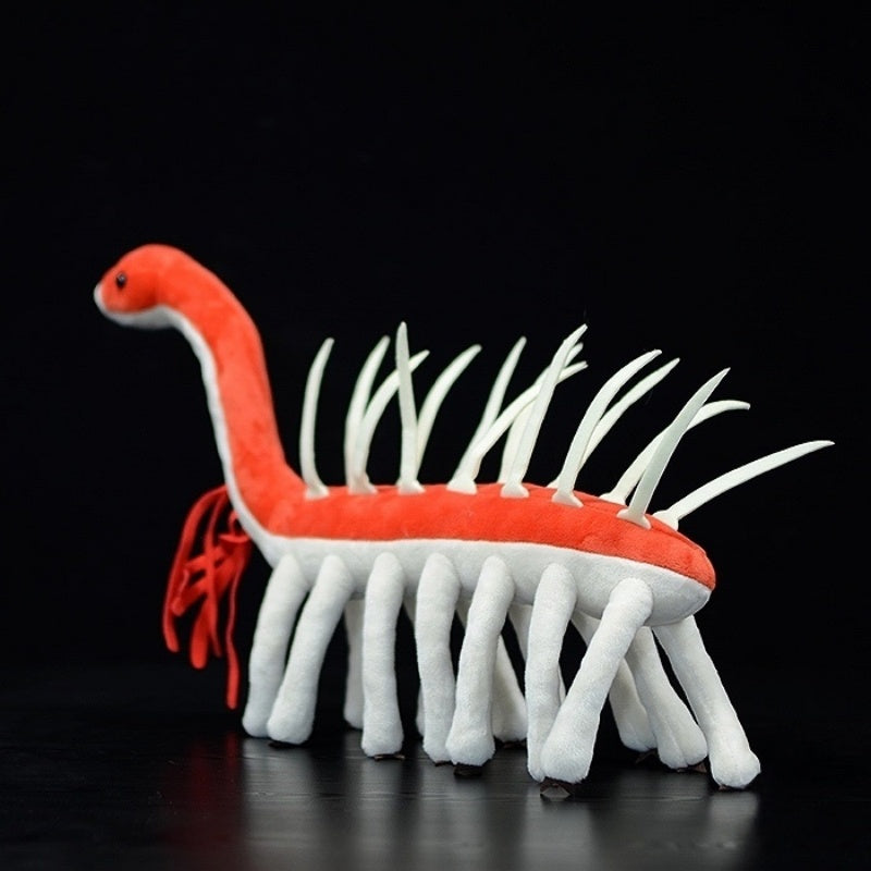 Side view of the Hallucigenia stuffed toy, highlighting its spines and soft, segmented legs