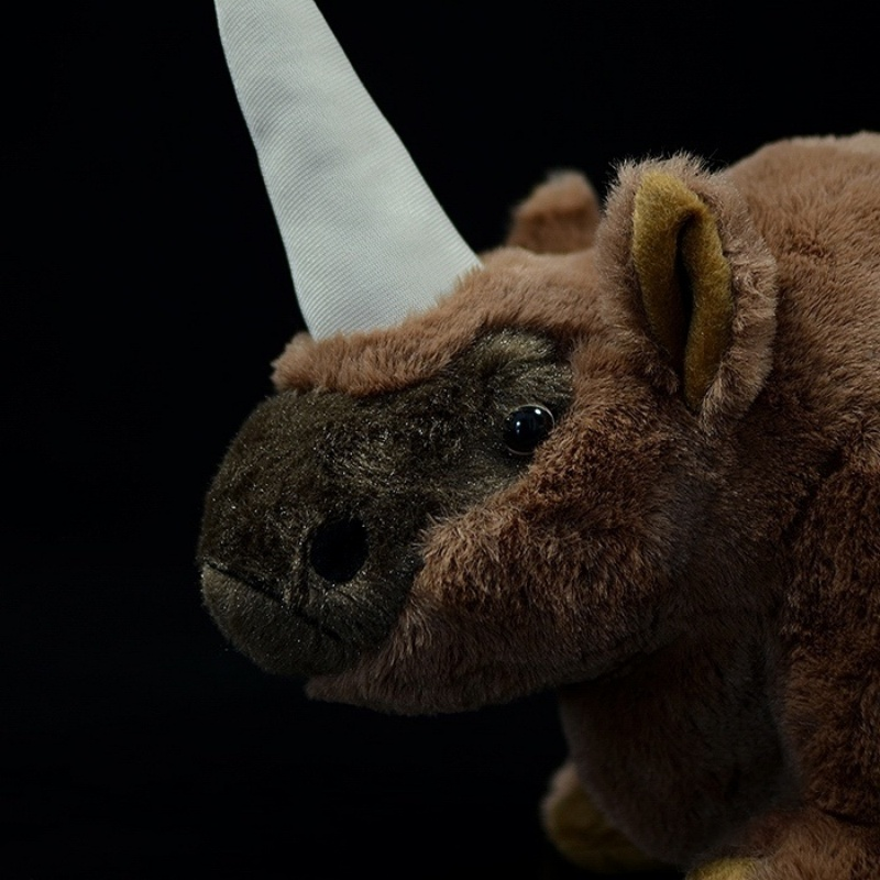Close-up of Elasmotherium plush toy's detailed face, focusing on its horn and lifelike features