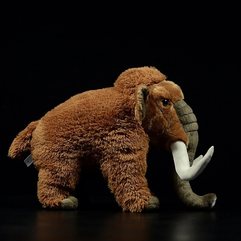 Side profile of woolly mammoth plush toy showing its realistic trunk and textured fur design